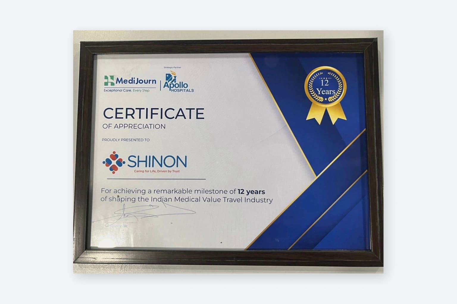 Apollo Hospitals Certificate of Appreciation presented to Shinon for a 12-year milestone