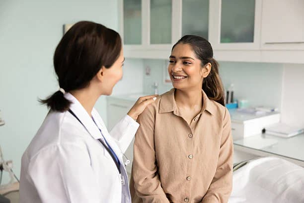 A doctor reassuring a patient during a consultation